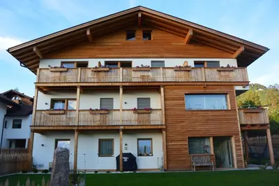 a large wooden house with a balcony at Haus Bernard in Siusi