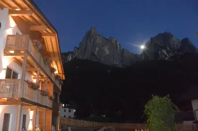a view of a mountain at night with the moon at Haus Bernard in Siusi