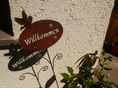 a sign on the side of a building with a bird on it at Planatscherhof in Barbiano