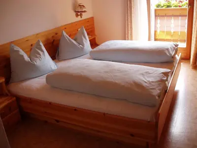 two beds with white pillows on them in a room at Planatscherhof in Barbiano