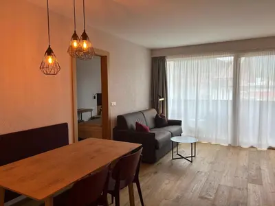 a living room with a table and a couch at Dining & Living Alpenrose in Bressanone