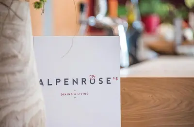 a white bag sitting on top of a table at Dining & Living Alpenrose in Bressanone
