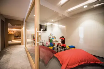 a room with a large mirror and a red pillow at Dining & Living Alpenrose in Bressanone