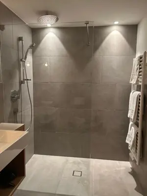 a bathroom with a shower with a glass door at Dining & Living Alpenrose in Bressanone