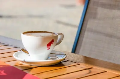 a cup of coffee sitting on a table at Pension Etschblick B&B in Frangarto