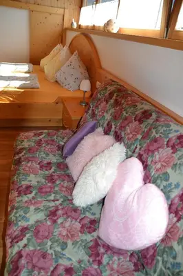 a bed with two stuffed animals on top of it at Burggräflerhof in Lana