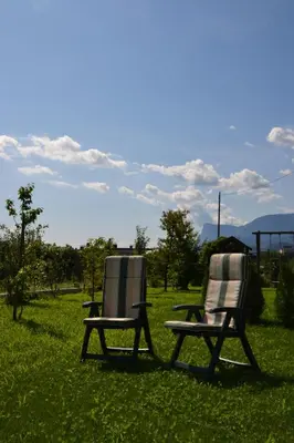 two chairs sitting on the grass in a field at Burggräflerhof in Lana