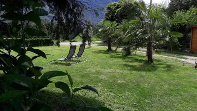two chairs sitting in the grass in a yard at Burggräflerhof in Lana
