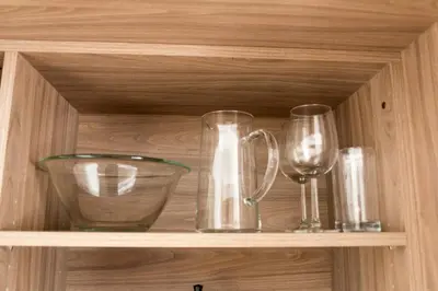 a wooden shelf with glass items on it at Apartments Sissi & Franz in Merano