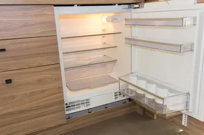an empty refrigerator with its door open at Apartments Sissi & Franz in Merano