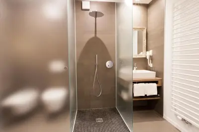 a shower with a glass door in a bathroom at Apartments Sissi & Franz in Merano