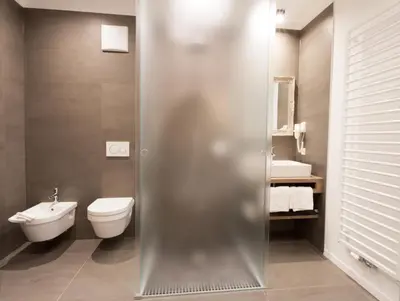 a bathroom with a toilet and a sink at Apartments Sissi & Franz in Merano
