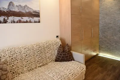 a living room with a leopard print couch at Apartments Mujnei in Santa Cristina in Val Gardena