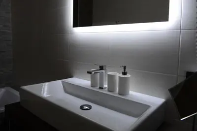 a white sink in a bathroom with a mirror at Apartments Mujnei in Santa Cristina in Val Gardena