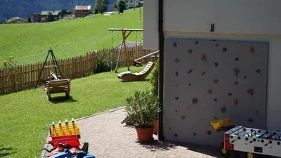 a backyard with a climbing wall and a playground at Alpegger in Terento