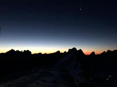 a view of the mountains at sunset at Hotel Fiames in Cortina dʼAmpezzo