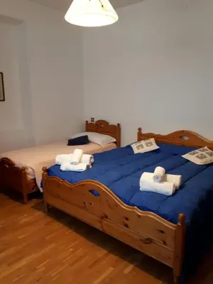 a bedroom with two twin beds with towels on them at Hotel Fiames in Cortina dʼAmpezzo