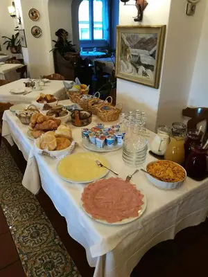 a table with many different types of food on it at Hotel Fiames in Cortina dʼAmpezzo