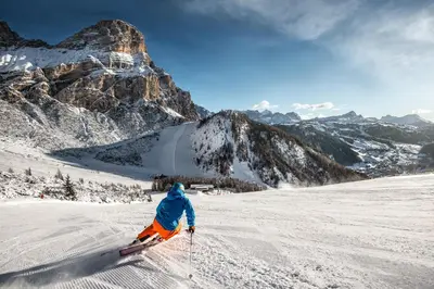 a person is skiing down a snow covered mountain at Pradel Dolomites in San Martino in Badia