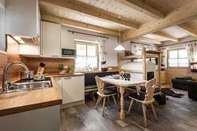 a kitchen and dining room with a table and chairs at Pradel Dolomites in San Martino in Badia