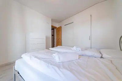 a white bedroom with two beds with towels on them at Olivia Home in Caprile