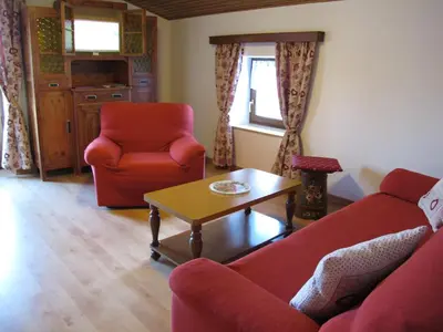 a living room with a couch and a chair and a table at Ospitalità Diffusa Laste Dolomites - Cèsa Murer in Pallua
