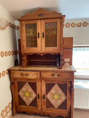 a wooden cabinet with glass doors in a kitchen at Ospitalità Diffusa Laste Dolomites - Cèsa Murer in Pallua