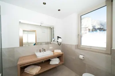 a bathroom with a sink and a mirror at Villa David Dolomites in Selva di Val Gardena