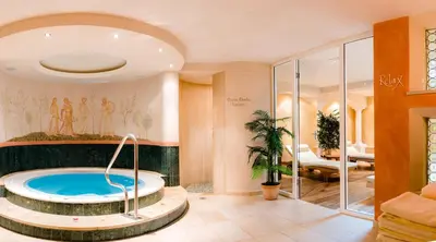 a large bathroom with a tub in the middle at Villa David Dolomites in Selva di Val Gardena