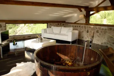 a living room with a tub and a couch and a couch at Grottnerhof in Fiè