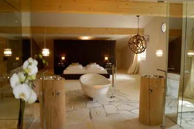 a bathroom with a bed and a toilet in a room at Grottnerhof in Fiè