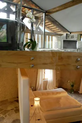 a room with two beds and a table with a lamp at Grottnerhof in Fiè