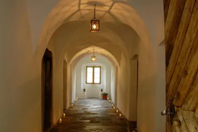 an aisle in a building with a window and lights at Grottnerhof in Fiè