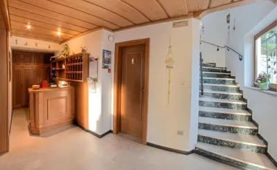 a staircase in a home with a wooden ceiling at Hammele Appartements in Schenna