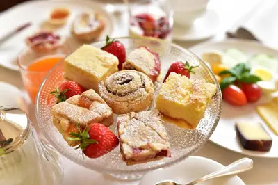 a plate of pastries and strawberries on a table at Ansitz Pünthof in Lagundo