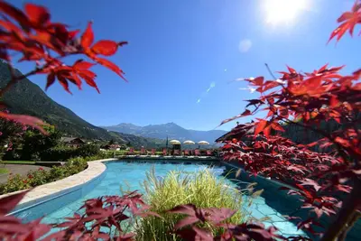 a swimming pool with mountains in the background at Ansitz Pünthof in Lagundo