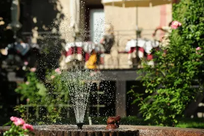 a fire hydrant spraying water in a fountain at Ansitz Pünthof in Lagundo