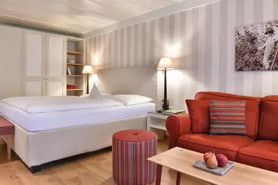 a hotel room with a bed and a couch at Ansitz Pünthof in Lagundo