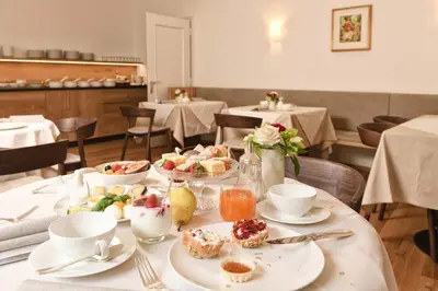 a table with plates of food on it in a restaurant at Ansitz Pünthof in Lagundo