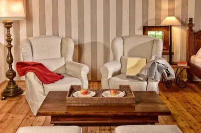 two chairs and a coffee table in a living room at Ansitz Pünthof in Lagundo