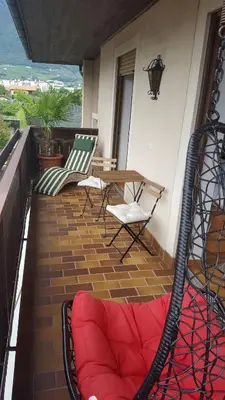 a balcony with chairs and a table and a couch at SonnenApartment in Lana