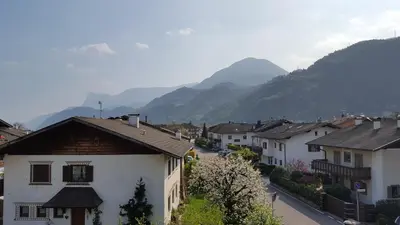 a view of a village with mountains in the background at SonnenApartment in Lana