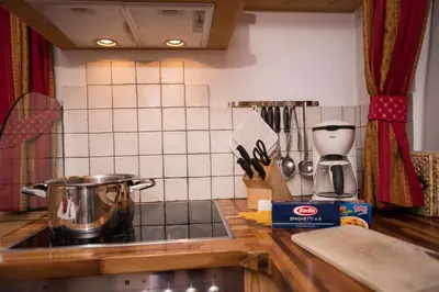 a kitchen counter top with a pot on a stove at Villa Schmalzl in Ortisei