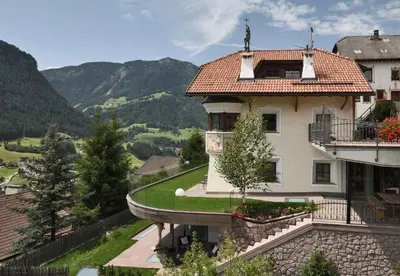 a building with a statue on top of it at Villa Schmalzl in Ortisei