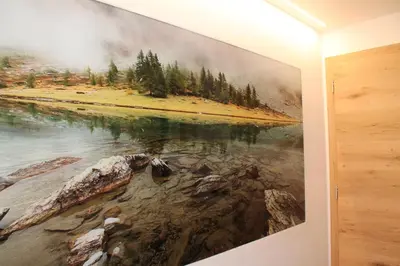 a painting of a river on a wall in a room at Natur Luch Sossach in La Villa