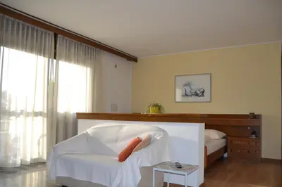a room with a white chair with a carrot on it at Haus Marion in Appiano sulla Strada del Vino