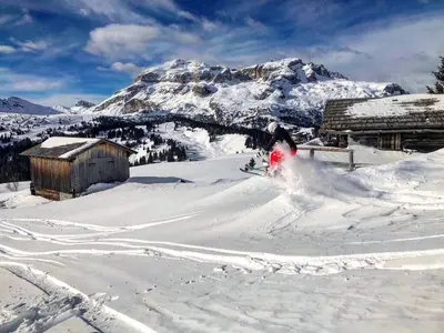 a person is skiing down a snow covered mountain at Garní Emma in Arabba