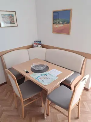 a dining room table and chairs with a wooden table at Guesthouse48 in Bolzano