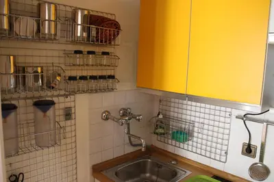 a kitchen with a sink and a yellow cabinet at Guesthouse48 in Bolzano