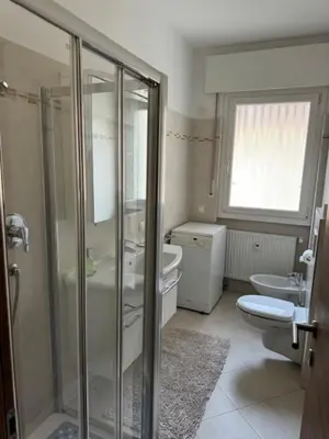 a bathroom with a shower and a toilet and a sink at Guesthouse48 in Bolzano